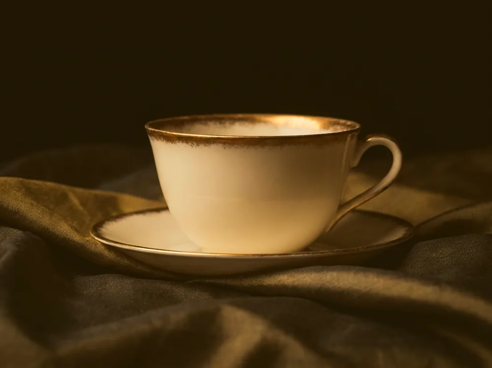 A bone-china cup and saucer with a gold rim